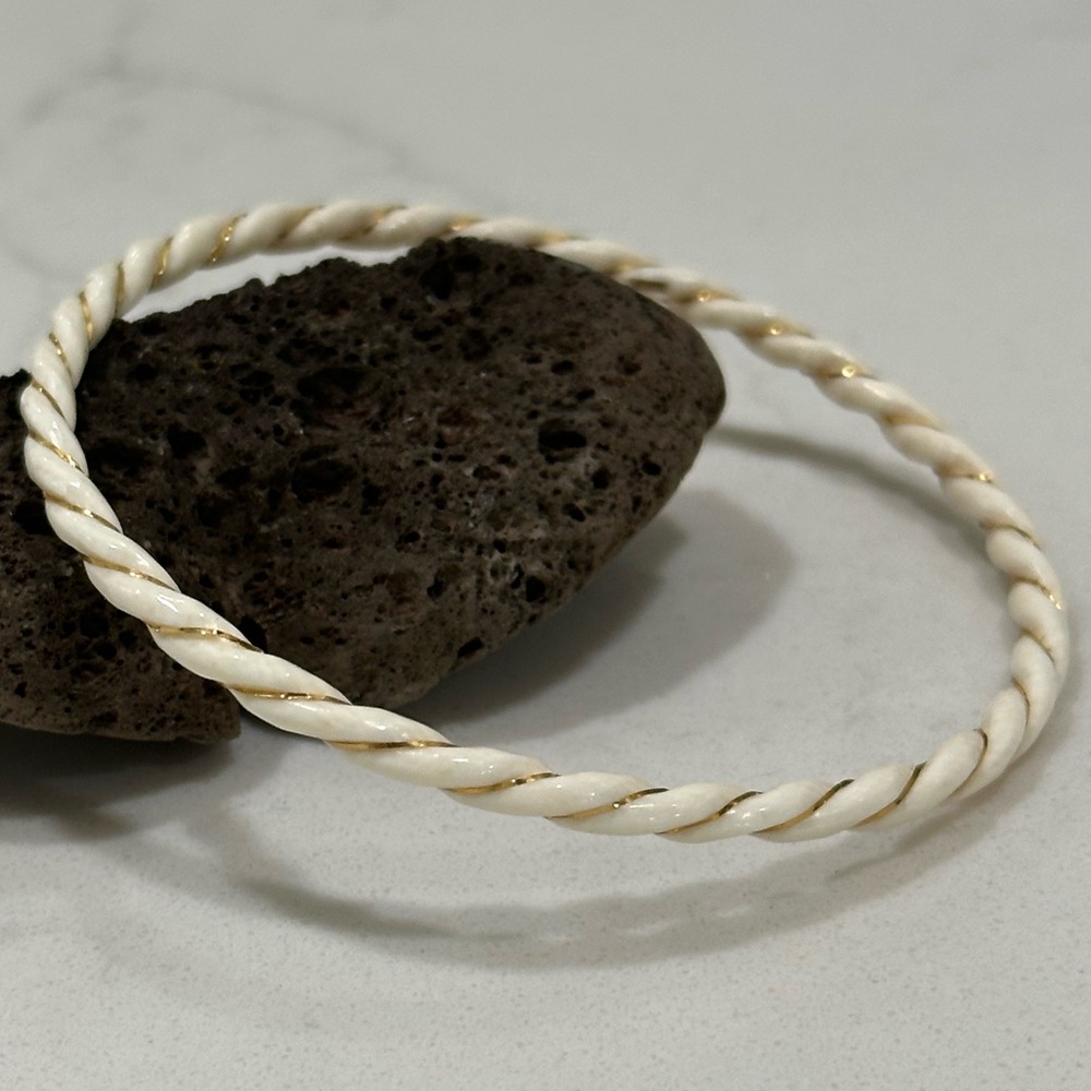 Elegant White Twisted Bangle Bracelet with Gold Accents